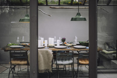 Dining table with place setting in backyard greenhouse