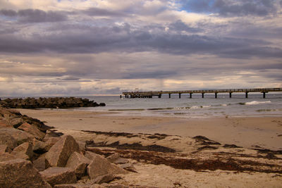 Bridge over sea against sky during sunset