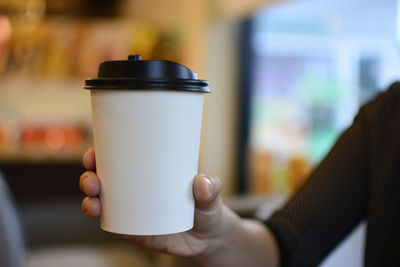 Midsection of woman holding coffee