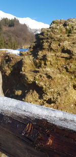 Close-up of cigarette on railing against mountain