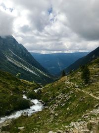 Scenic view of valley and mountains against sky