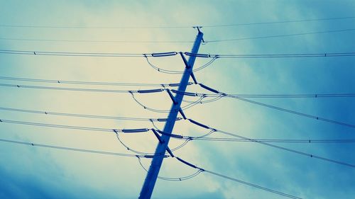 Low angle view of electricity pylon against sky