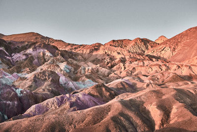 Colored rocks in death valley against blue