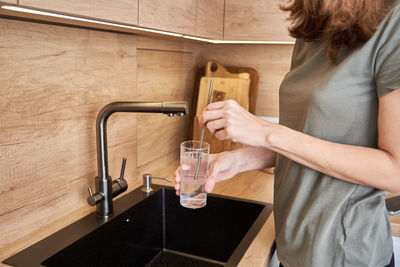 Woman drinks clean water from a glass