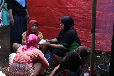 Rear view of people sitting outdoors