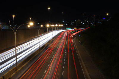 High angle view of light trails on road at night