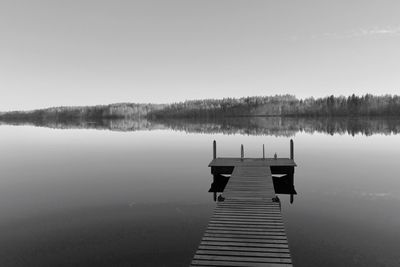Pier on lake against sky