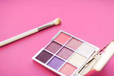 Close-up of beauty products against pink background