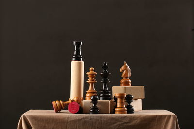 Close-up of bottles on table against black background