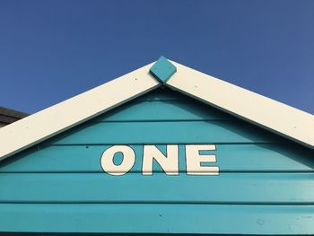 Close-up of road sign against clear sky