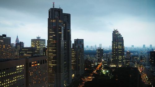 Skyscrapers in city at dusk