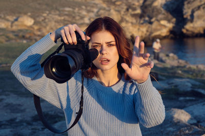 Portrait of woman photographing