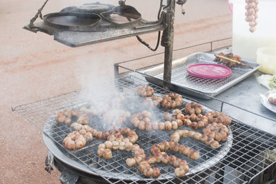 High angle view of meat on barbecue grill