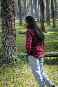 Young woman standing in forest