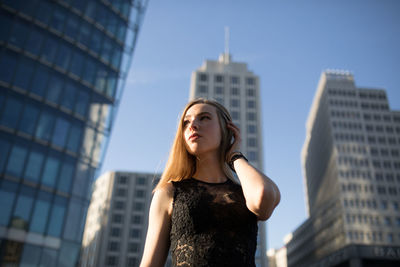 Young woman against modern buildings in city