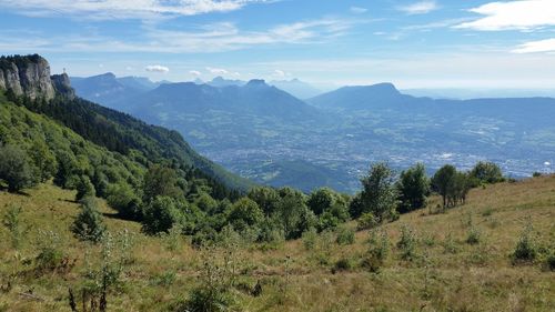 Scenic view of mountains against cloudy sky