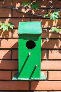 Close-up of birdhouse on wall