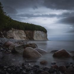 Rocks in sea against sky