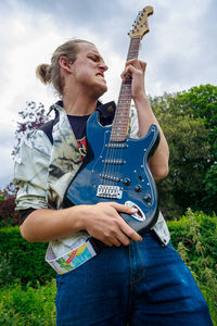 Full length of man playing guitar