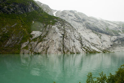 Scenic view of lake and mountains against clear sky