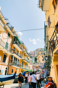 People on street against buildings in city