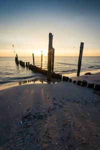 Scenic view of beach against sky during sunset