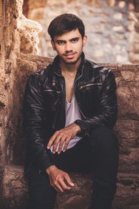 Portrait of young man sitting on steps