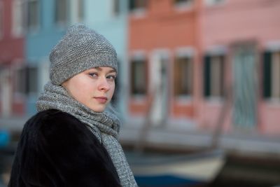 Portrait of beautiful young woman in city