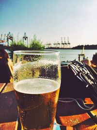 Close-up of beer in glass against sky