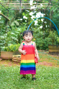 Portrait of cute girl standing on field