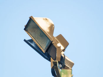 Low angle view of camera against clear blue sky