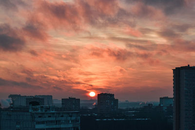 High angle view of buildings against dramatic sky