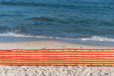 Beach screen on the polish beach on a sunny summer day in the background beautiful sea.