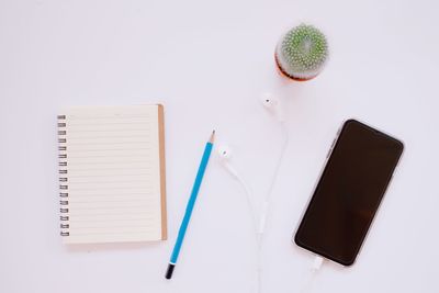 High angle view of books on table against white background