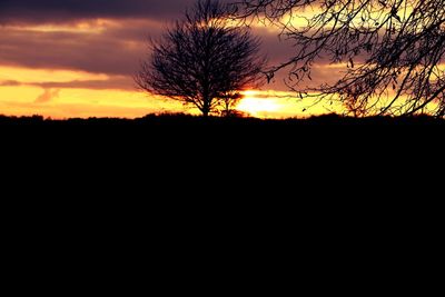 Scenic view of silhouette landscape against dramatic sky