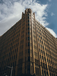 Low angle view of building against cloudy sky