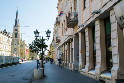 Street amidst buildings against sky in city