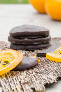 Close-up of chocolates with oranges on table