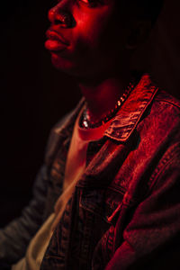 Close-up of young man against black background