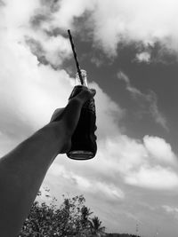 Low angle view of hand against sky