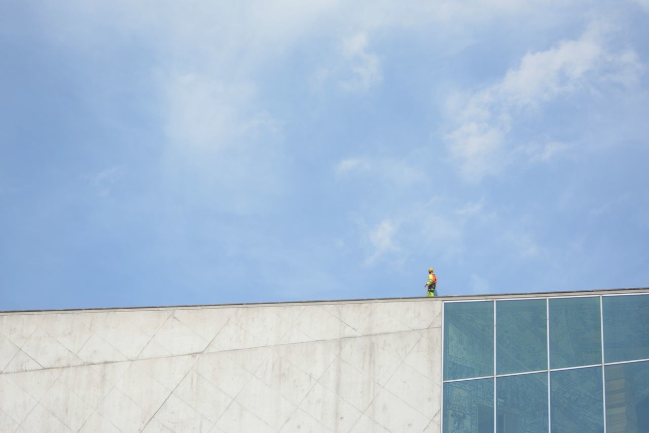 low angle view, architecture, built structure, building exterior, sky, high section, building, blue, day, modern, cloud - sky, cloud, outdoors, pattern, city, no people, office building, tower, architectural feature, wall - building feature