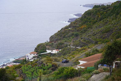 High angle view of houses at coast by sea near garachico, tenerife, canary islands