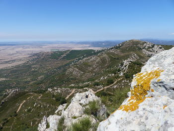 Aerial view of mountain by sea against sky