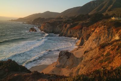 Scenic view of beach against sky during sunset