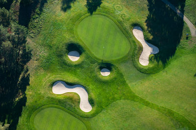 High angle view of golf course by lake