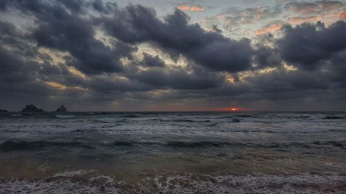 Scenic view of sea against cloudy sky