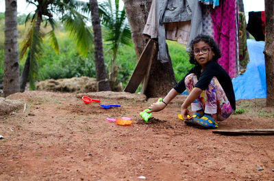 Portrait of boy playing on tree