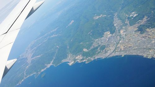 Aerial view of sea and airplane wing