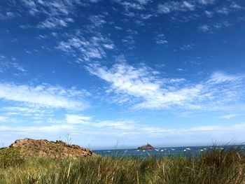 Scenic view of beach against blue sky