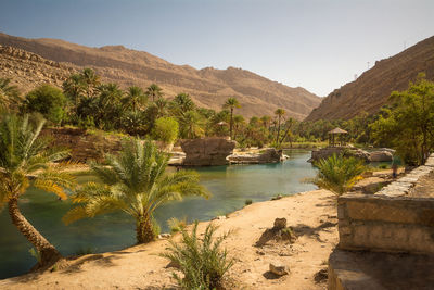 Scenic view of river and mountains against clear sky